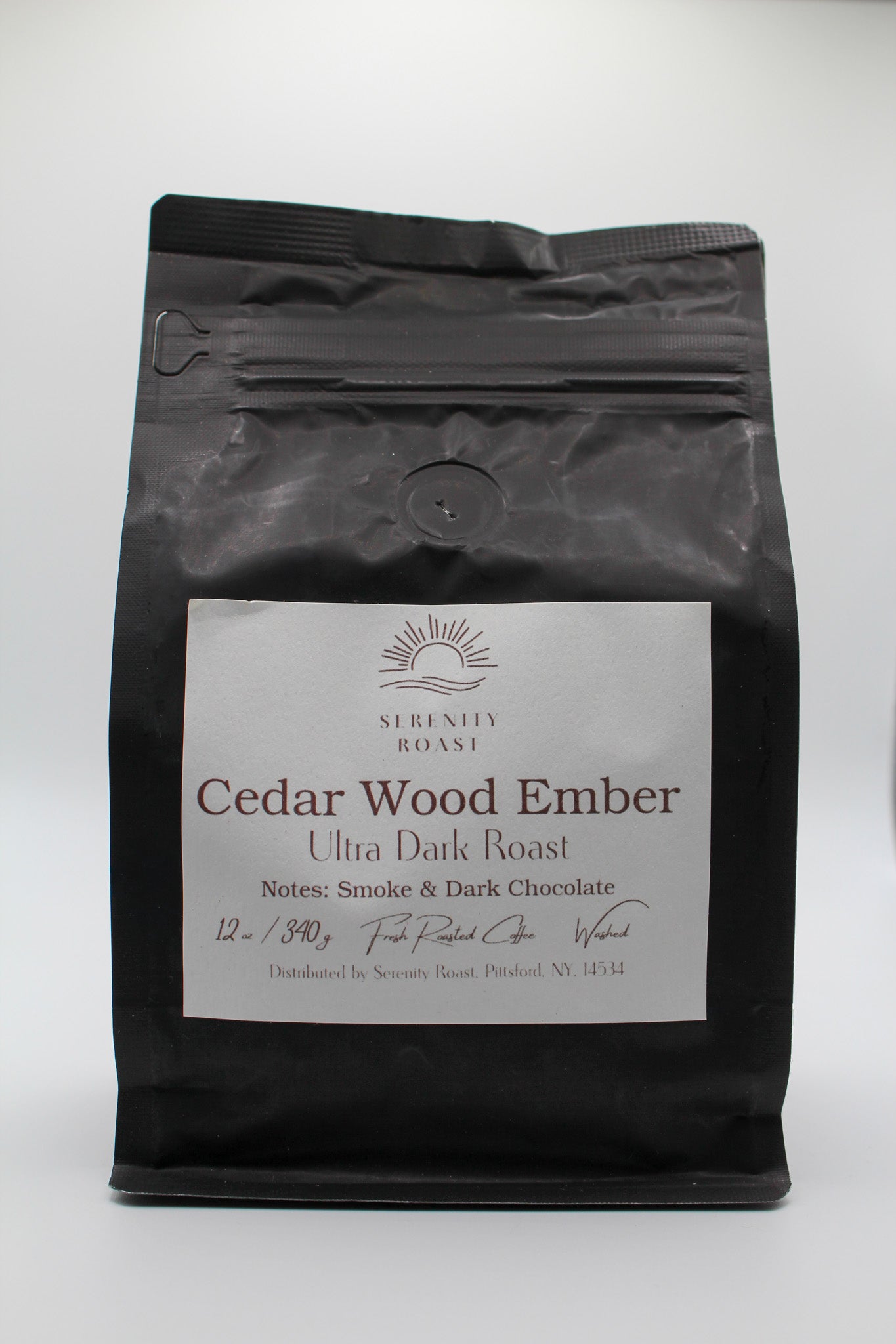Black coffee bag labeled 'Cedar Wood Ember' with a white label on a white background