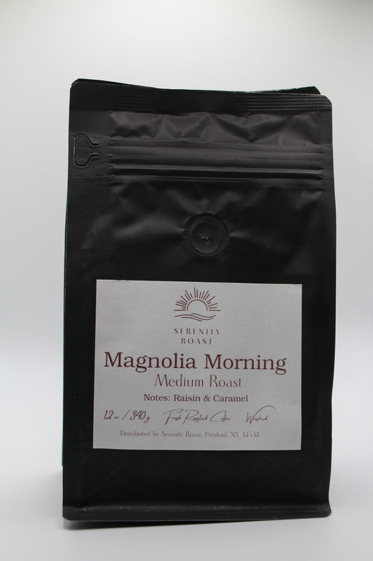 Black coffee bag labeled 'Magnolia Morning' on a white background